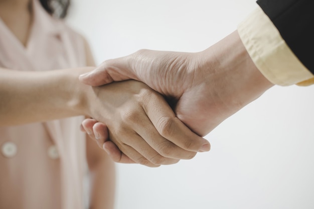 business people partner shaking hand after business signing contract desk in meeting room