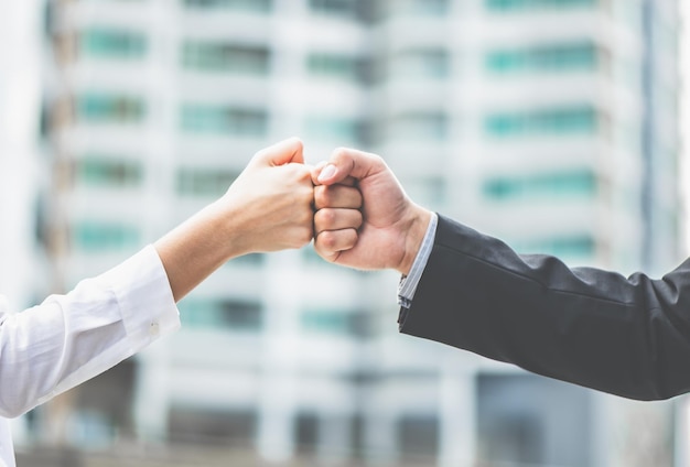 Business people of a Partnership Team Giving Fist Bump after meetingxASuccess mission team meeting group of People Hands togetherxAPartners agree to cooperate to run a business successfully