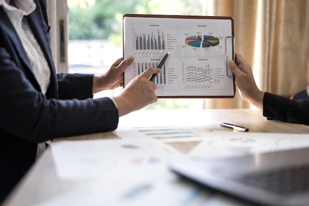  business people pointing at business document during discussion 