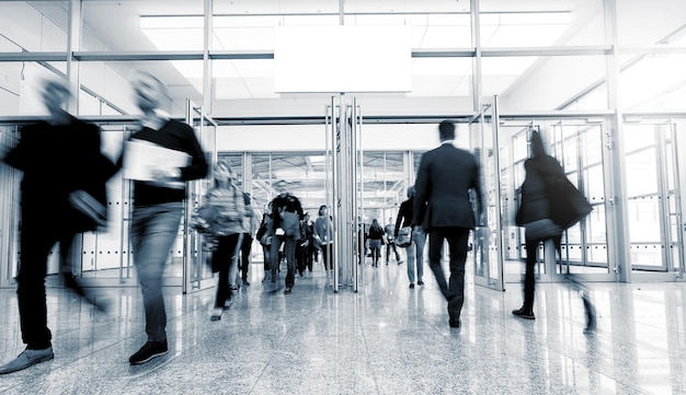 business people rushing in a entrance at a trade show. ideal for websites and magazines layouts