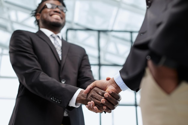 Business people shake hands standing in the office