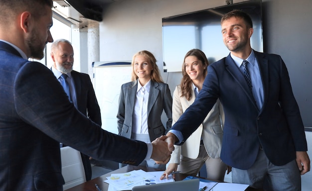 Business people shaking hands, finishing up a meeting.