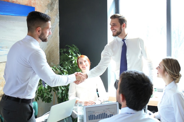 Business people shaking hands, finishing up a meeting.