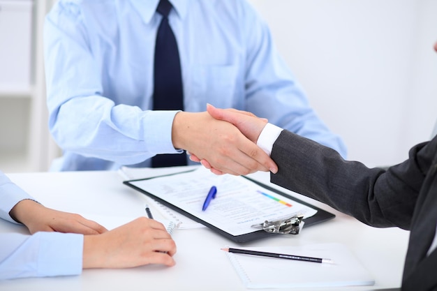 Business people shaking hands, finishing up a meeting.