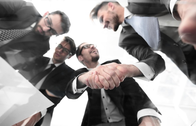 Business people shaking hands over the office Desk