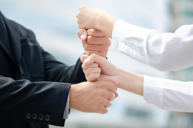 Business people showing unity with their hands together