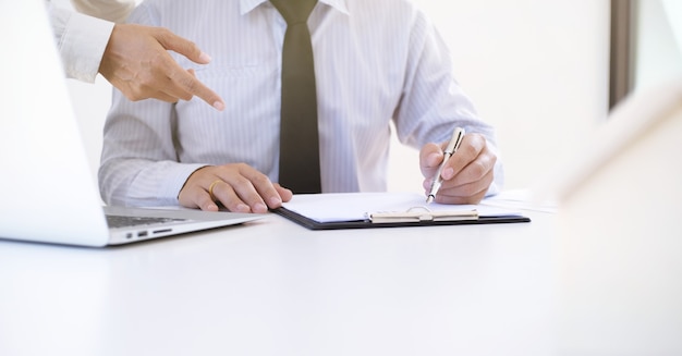 Business people signing contract making a deal with real estate agent