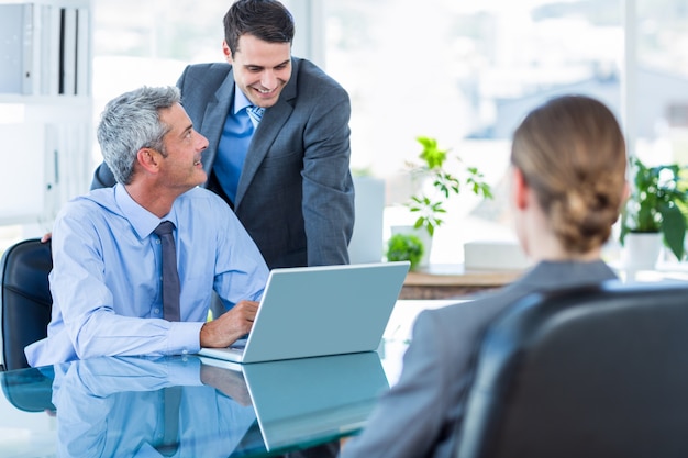 Business people speaking together during meeting 