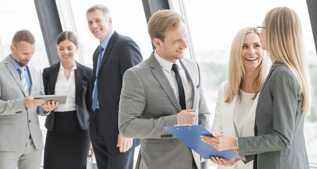 Business people talking at meeting in office near window