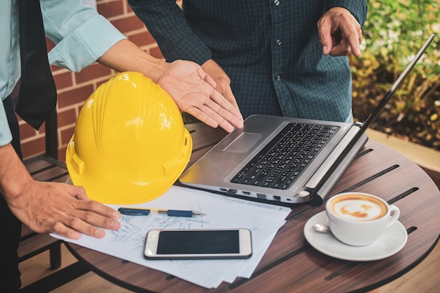 Photo business people  two people meeting construction project at the computer notebook on desk,businessman foreman supervisor hard hat laptop worker