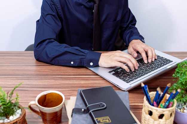 Business people use computers to work at their desks