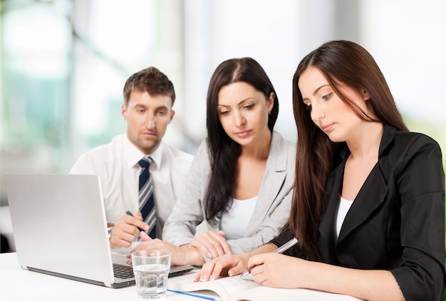 Business people using laptop at office on background