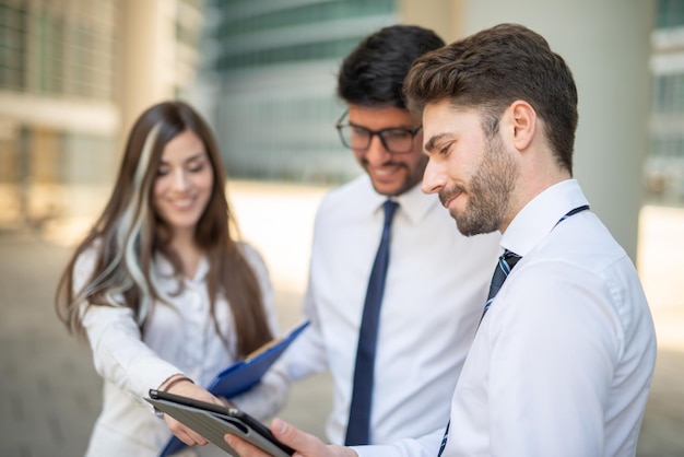 Business people using a tablet outdoor