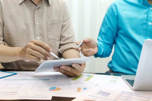 Business people using tablet at working with financial