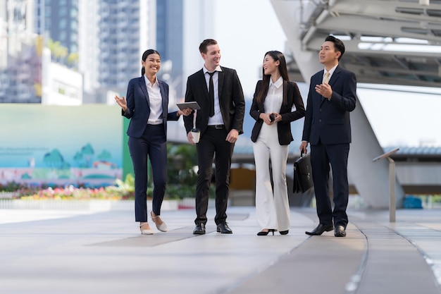 Business people walking and talk to each other in front of modern office