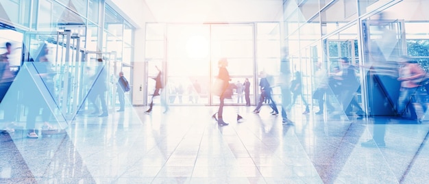 Business people walking and talking in a modern company office. Geometric pattern and skyscrapers foreground. Toned image double exposure mock up blurred