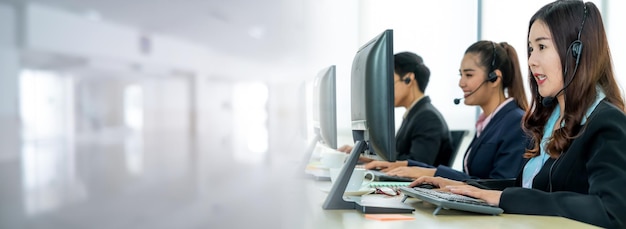 Business people wearing headset working in office in widen view