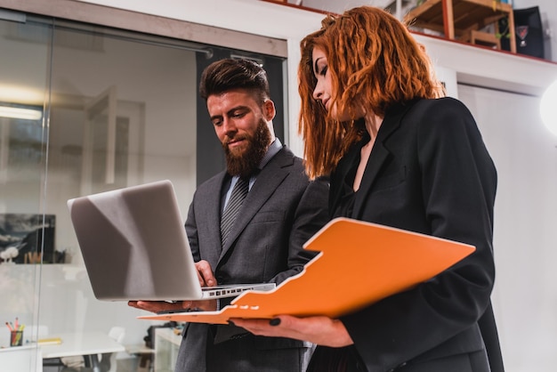 Business people work together in office with a laptop as a team and partner