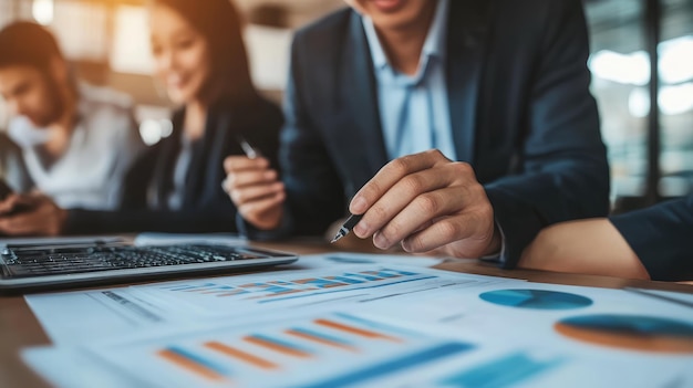 business people working at a desk with a graph and a man in the background