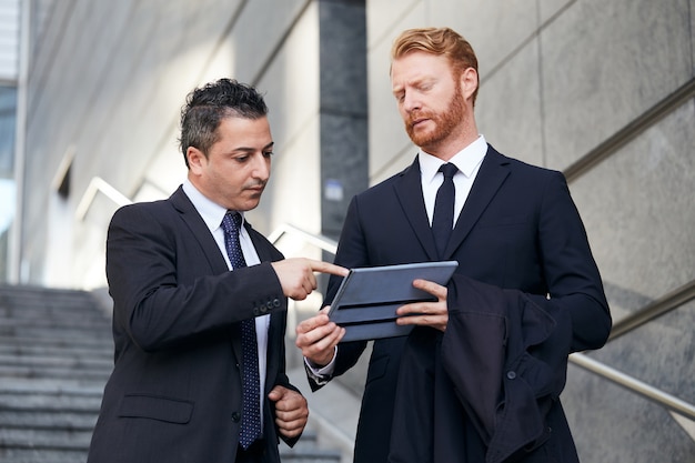 Business people working outside office building