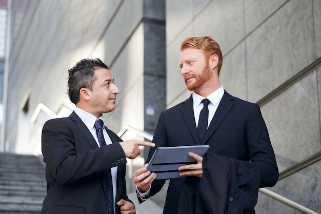 Business people working outside office building