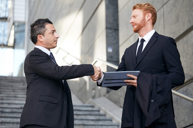 Business people working outside office building