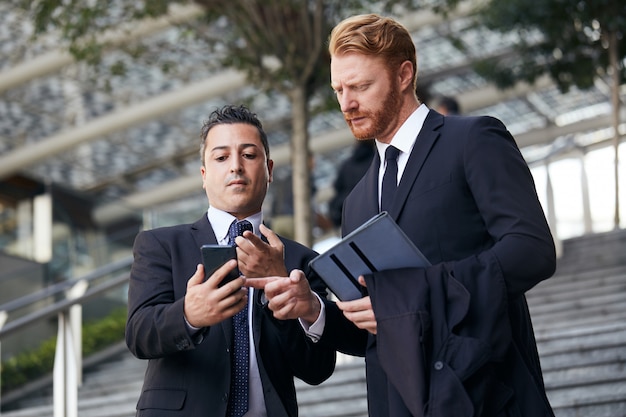 Business people working outside office building