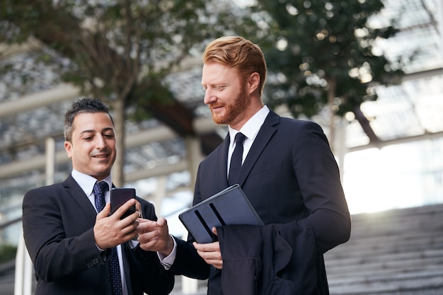 Business people working outside office building