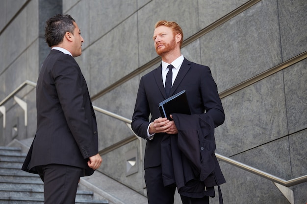 Business people working outside office building