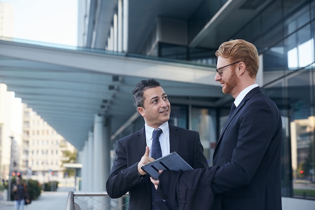 Business people working outside office building