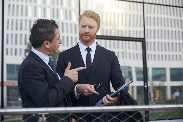 Business people working outside office building