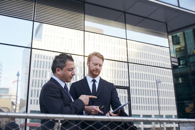 Business people working outside office building