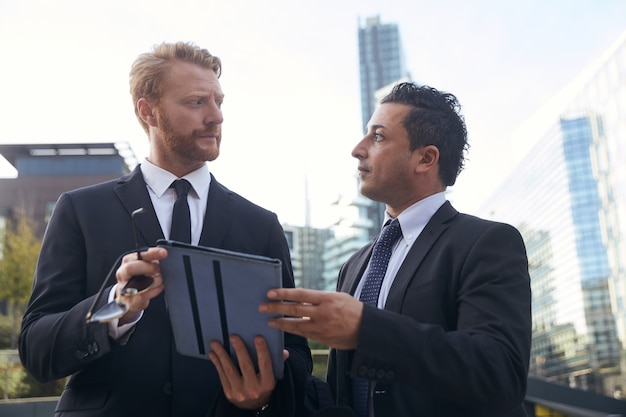 Business people working outside office building