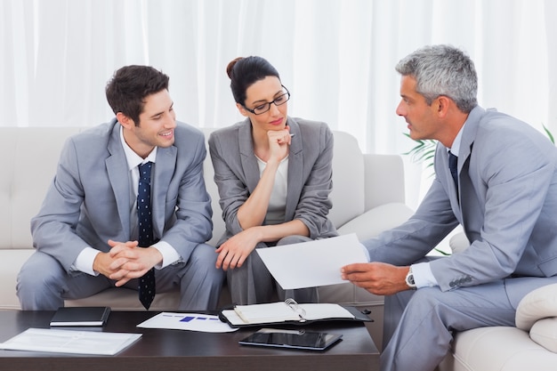 Business people working and talking together on sofa 