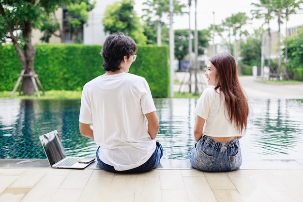 Business people working together by swimming pool during vacation at home