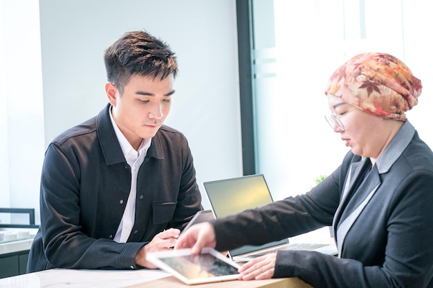 Business people working together looking at tablets in office