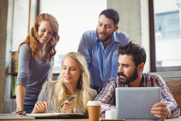 Business people working while discussing in office