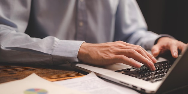 Business person hands typing on computer keyboard closeup banner businessman or student using laptop at home online learning internet marketing working from home office workplace freelance