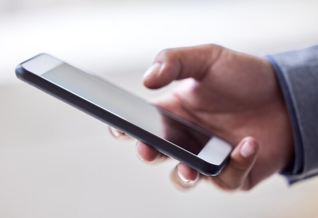 Photo business person hands and typing with phone screen for communication news or online browsing at office closeup of employee scrolling chatting or texting on mobile smartphone display at workplace