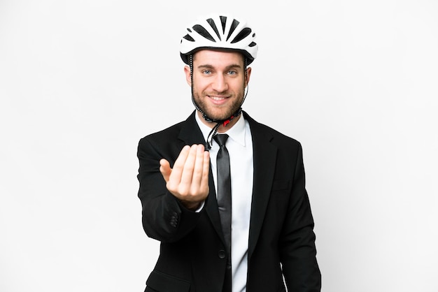 Business person with a bike helmet over isolated white background inviting to come with hand Happy that you came