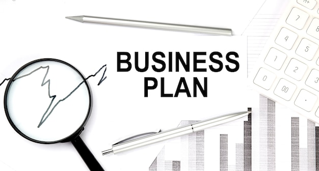 Business plan document with pen,graph and magnifier,calculator