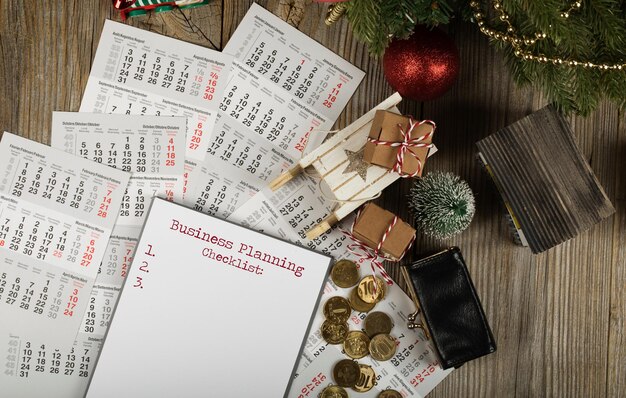 Photo business planning checklist. small purse with coins on the new year's background. top view