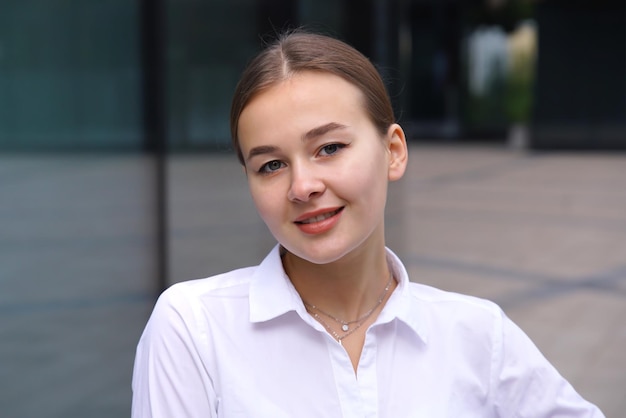 Business portrait of elegant beautiful girl young teen teenager woman in white formal shirt university or college student looking at camera Office worker businesswoman