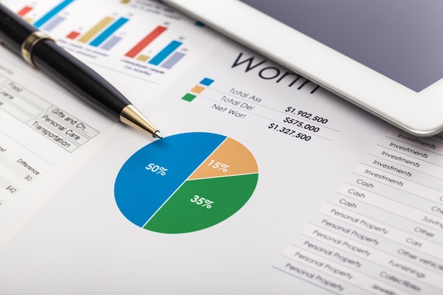 Business report with charts and pen, background