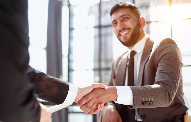 Business shaking hands finishing up meeting successful businessmen handshaking after good deal