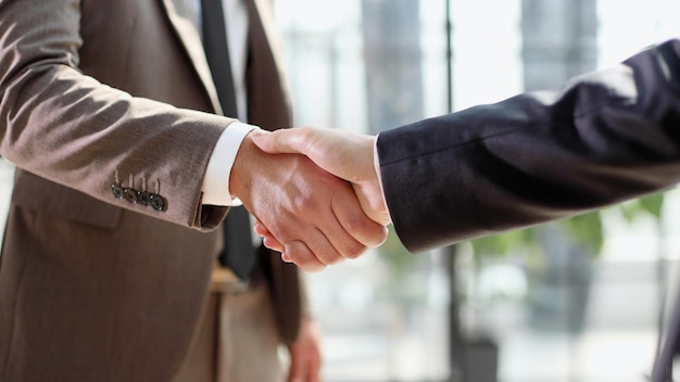 Business shaking hands finishing up meeting Successful businessmen handshaking after good deal