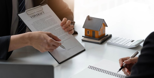 Business Signing a Contract Buy sell house Home for rent concept broker agent presenting and consult detail to customer to making the decision a home estate loan to customer sign form agreement