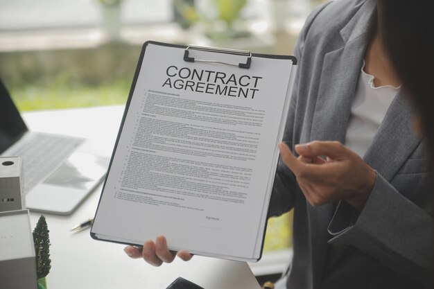 Photo business signing a contract buy sell house insurance agent analyzing about home investment loan real estate concept