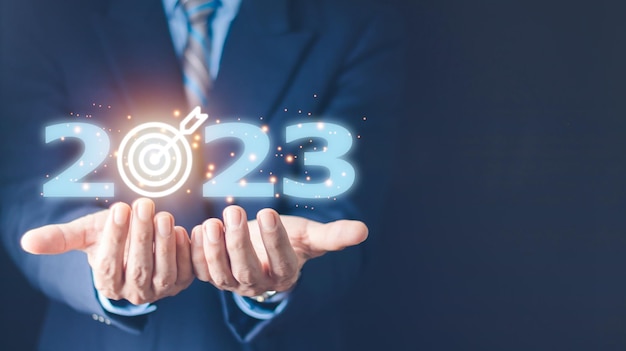 Business target and goal on New year 2023 concept hand holding 2023 virtual screen new years business new ideas coming up in the future