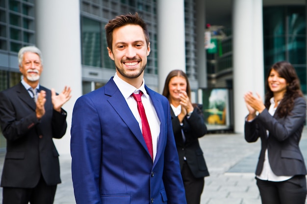 Business team celebrating a success of a colleague